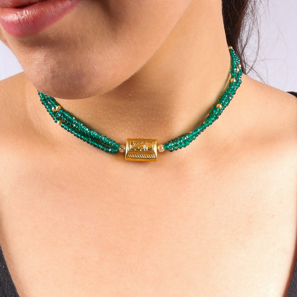 Model wearing green onyx beaded necklace with gold clasp and adjustable fit