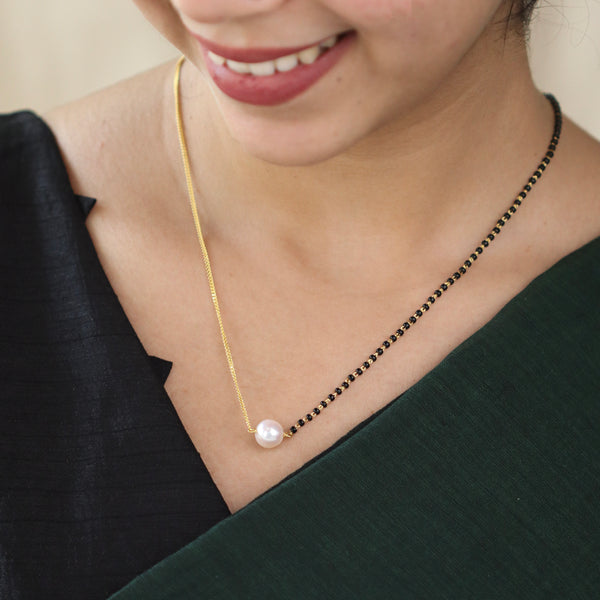 Pearl and black bead necklace with gold chain detail
