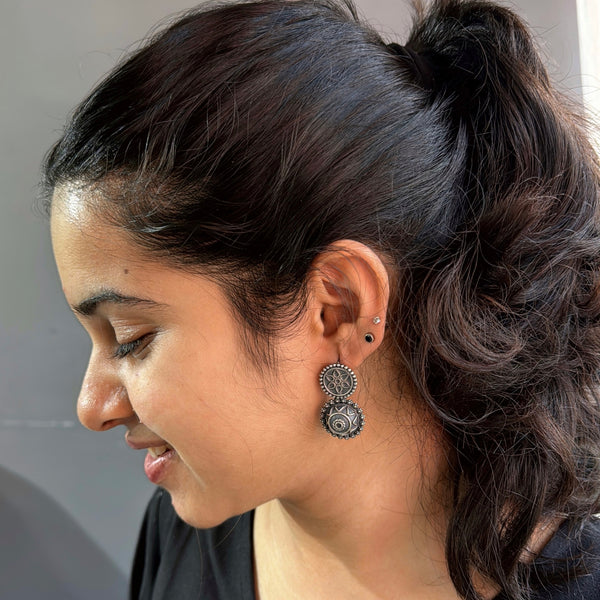 Silver tribal earrings with intricate circular design