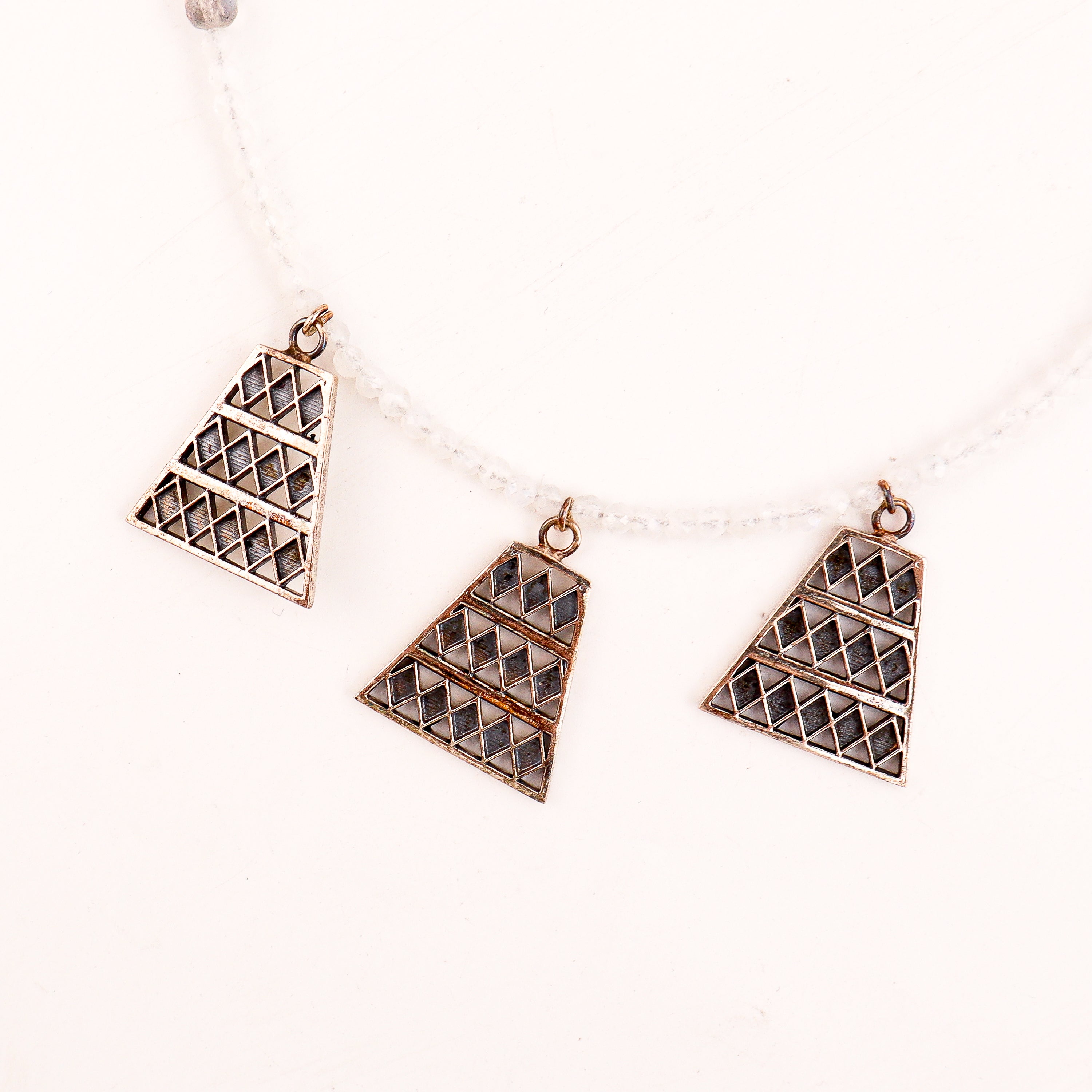 Detail shot highlighting polished silver finish and moonstone glow