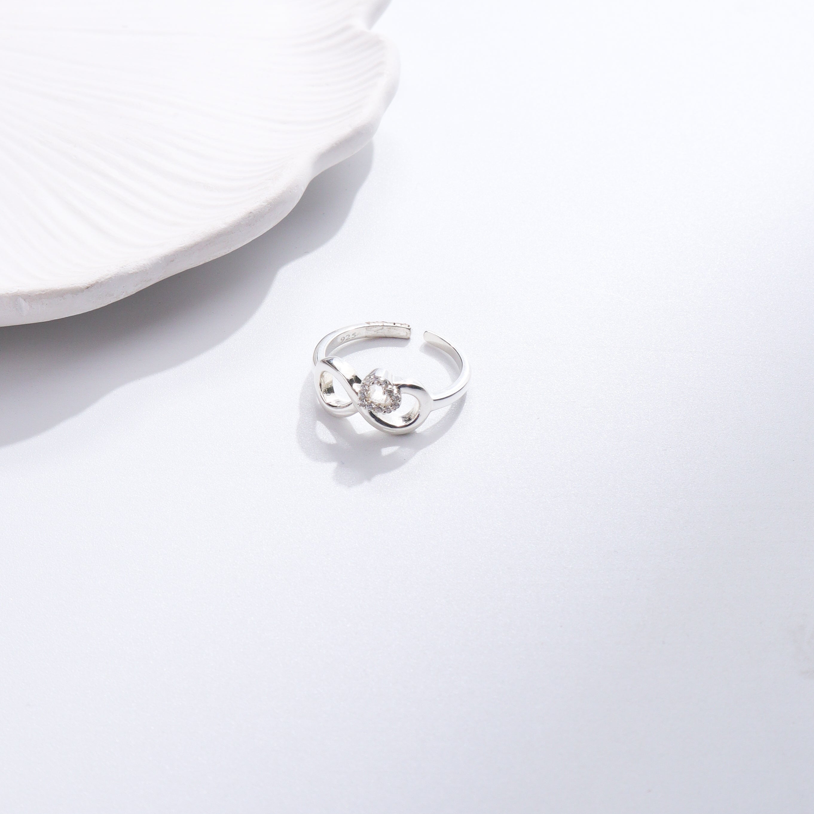 Silver CZ infinity heart ring on white background