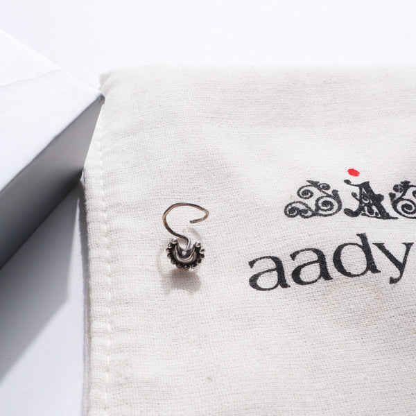 Silver nose pin on Aadyaa jewelry pouch