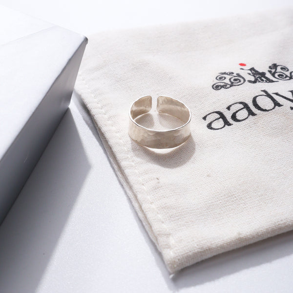 Unisex hammered silver adjustable ring on fabric with Aadya logo