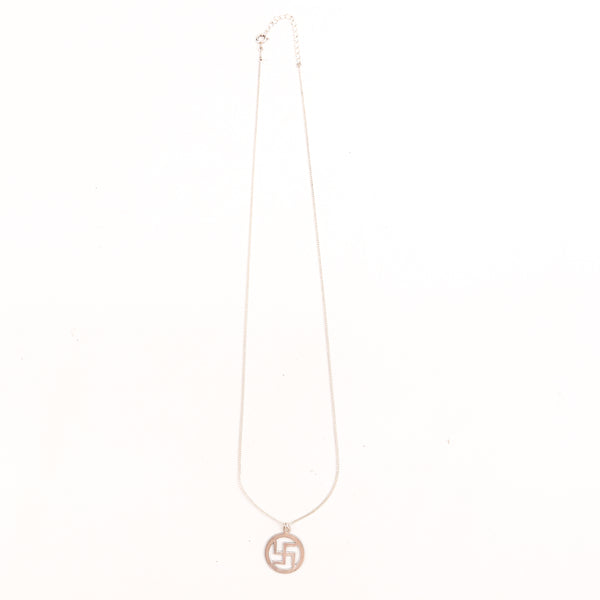 Detail shot highlighting polished silver finish of swastik pendant
