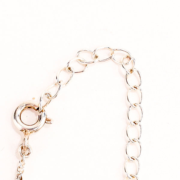 Swastik silver pendant styled with kurta and casual outfit