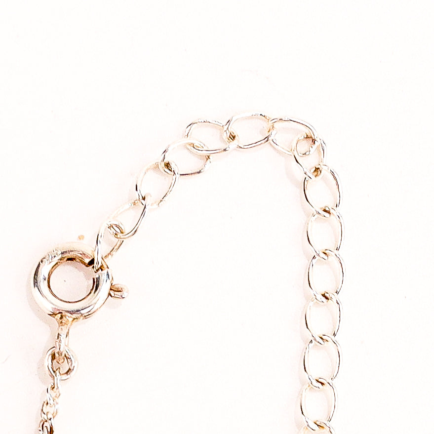 Swastik silver pendant styled with kurta and casual outfit