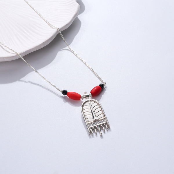 Silver necklace with red and black beads, silver pendant, jewelry display