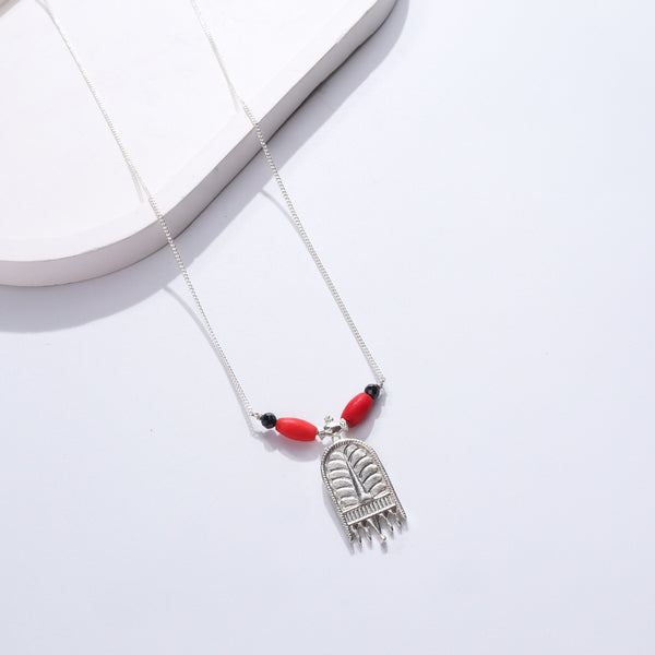 Silver necklace with red and black beads and pendant