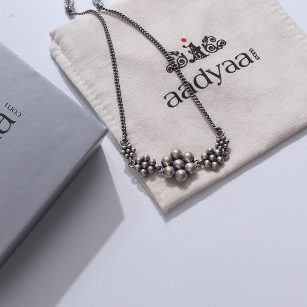 Silver 5 Kudi Choker necklace with traditional motifs on beige fabric