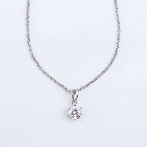 Close-up of silver chain with cubic zirconia pendant and matching earrings