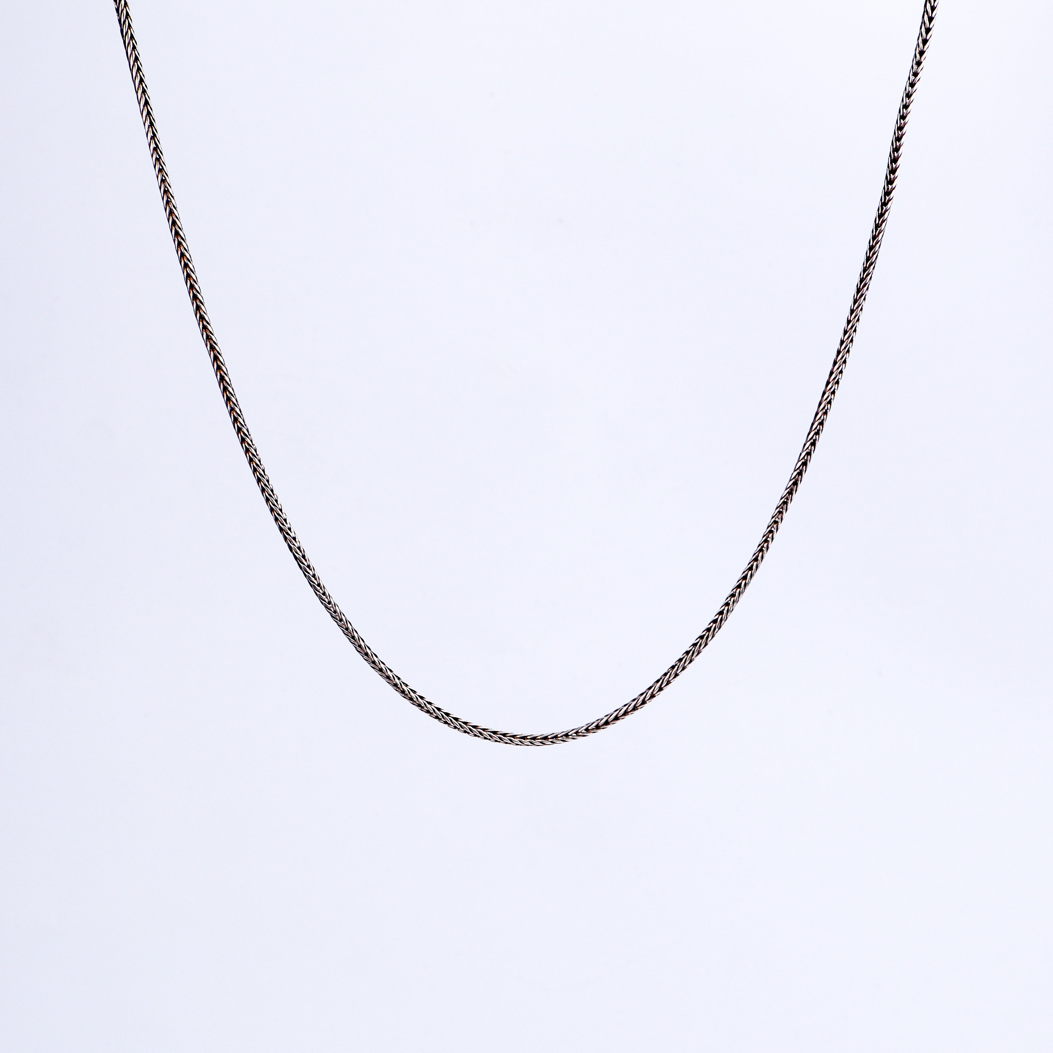 Detail shot highlighting polished silver chain finish