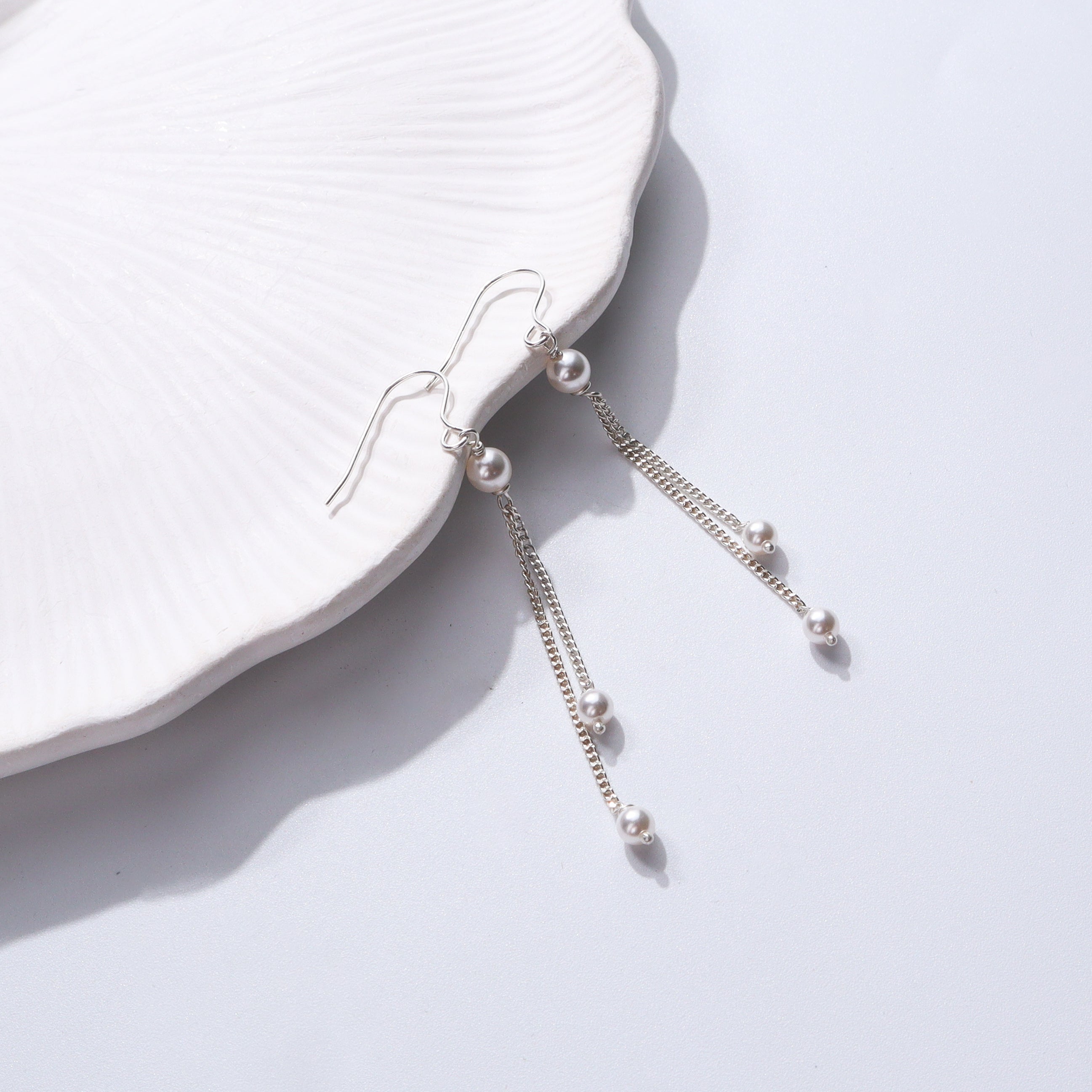 Elegant pearl dangler earrings with silver chains for women