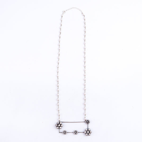 Flat-lay handmade kudi abstract silver necklace with pearls
