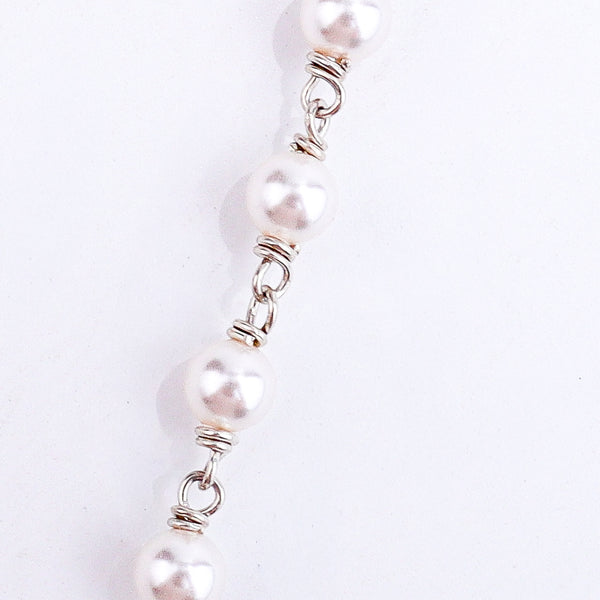 Detail shot highlighting pearl accents and silver craftsmanship