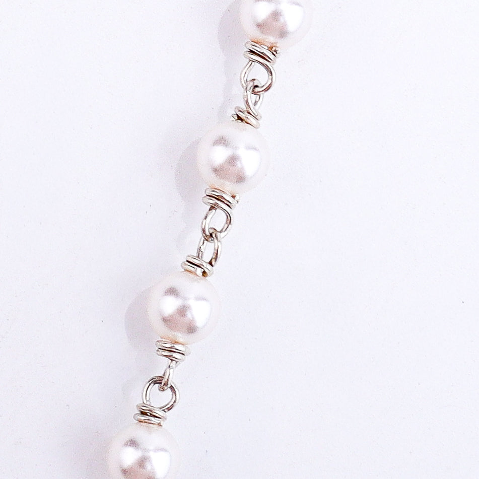 Detail shot highlighting pearl accents and silver craftsmanship