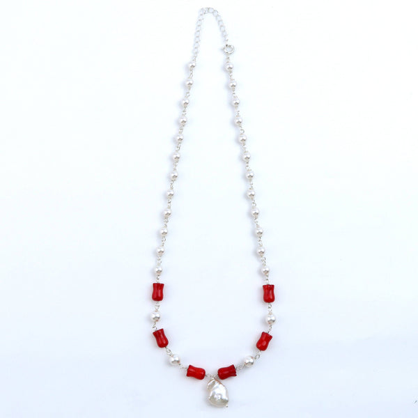 Flat-lay of pearl Ganthan necklace with semiprecious stones on silk fabric and soft lighting