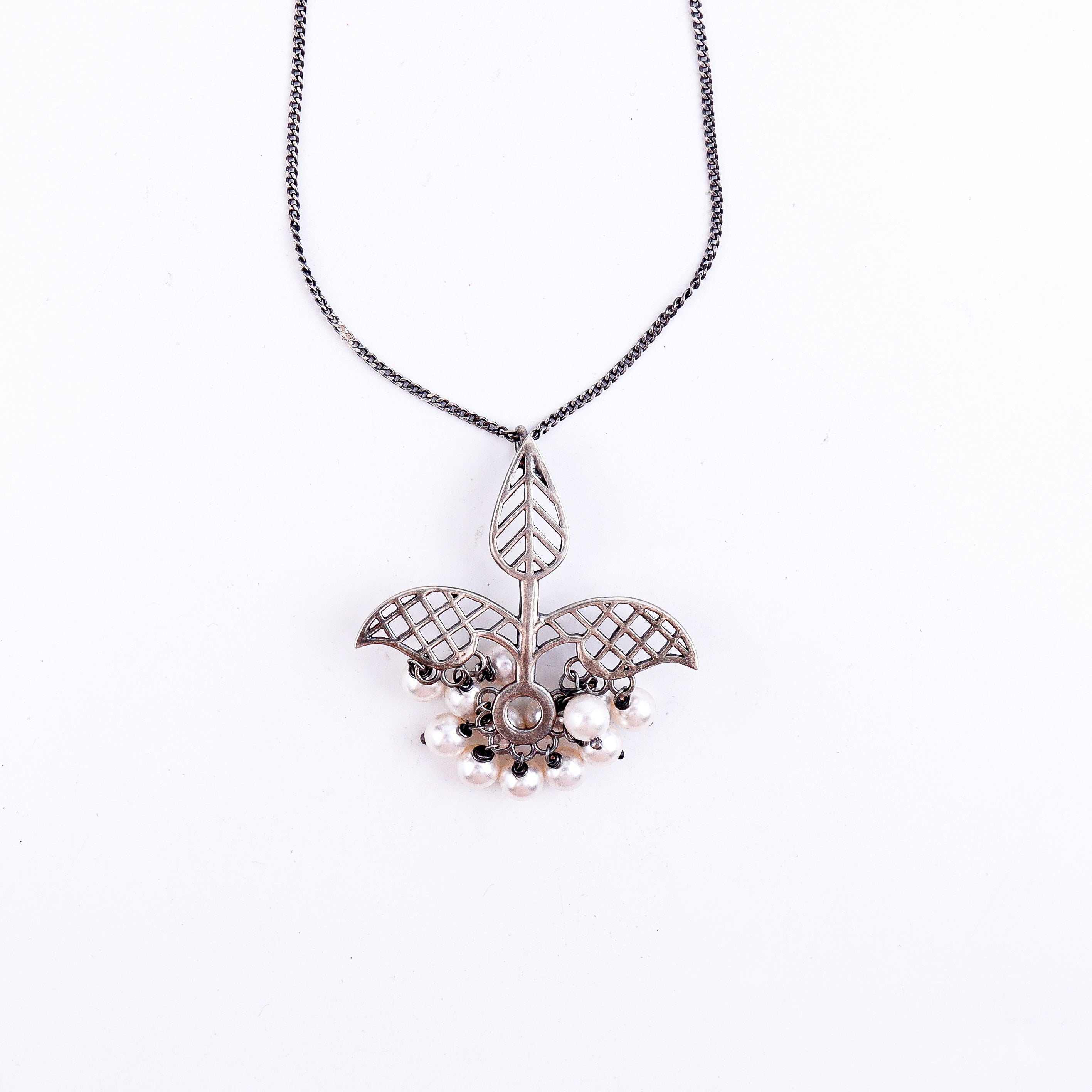 Detail shot highlighting intricate filigree work and oxidized finish