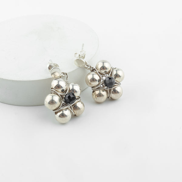 Detail shot of silver bead thushi pattern and spinel accents