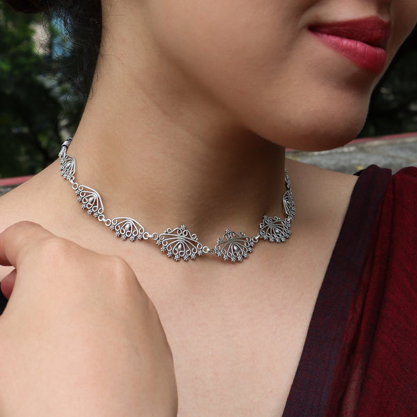 Close-up of silver necklace and earrings