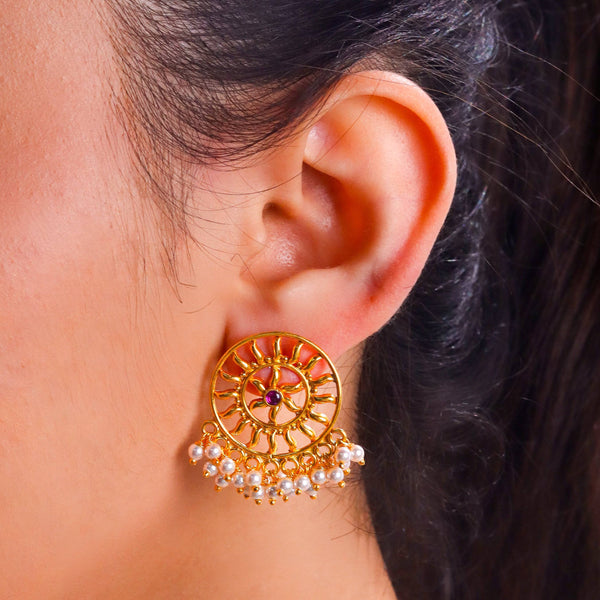 Close-up of Sun Pearl Earrings highlighting radiant pearl and intricate 22K gold plated detailing
