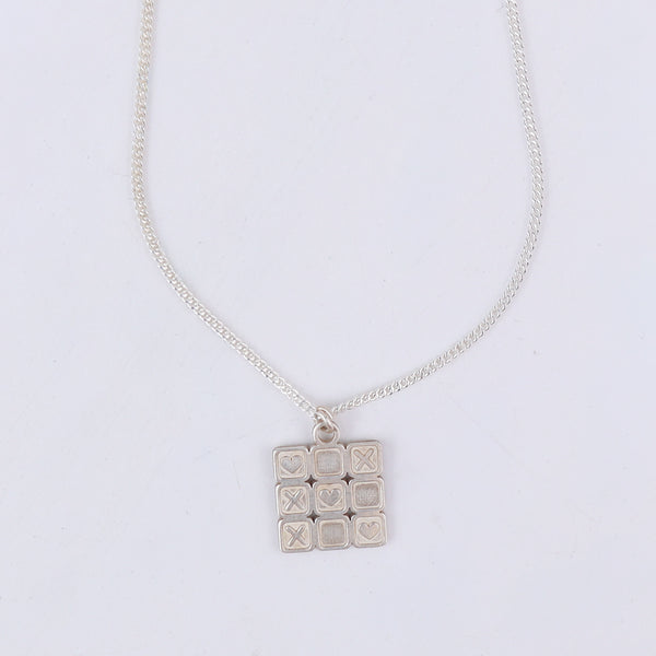 wear big tic tac toe pendant necklace for statement styling