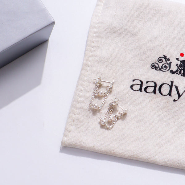 Pearl Drop Earrings on fabric
