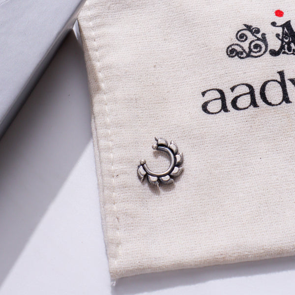 Sterling silver septum nose ring on beige jewelry pouch