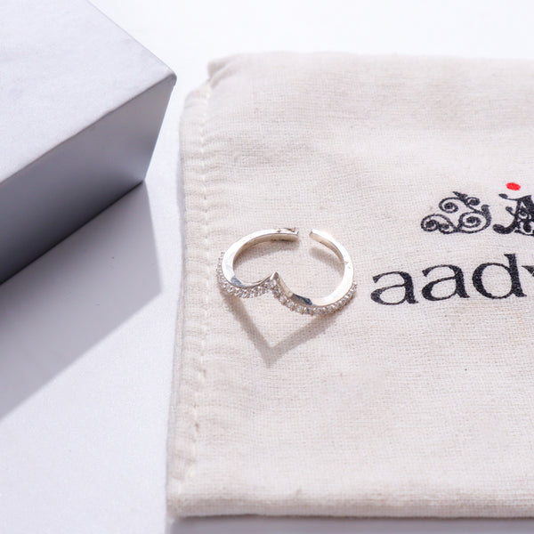 Silver CZ V Ring on white fabric with packaging