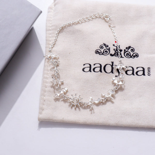 Silver bracelet with Warli motifs on fabric