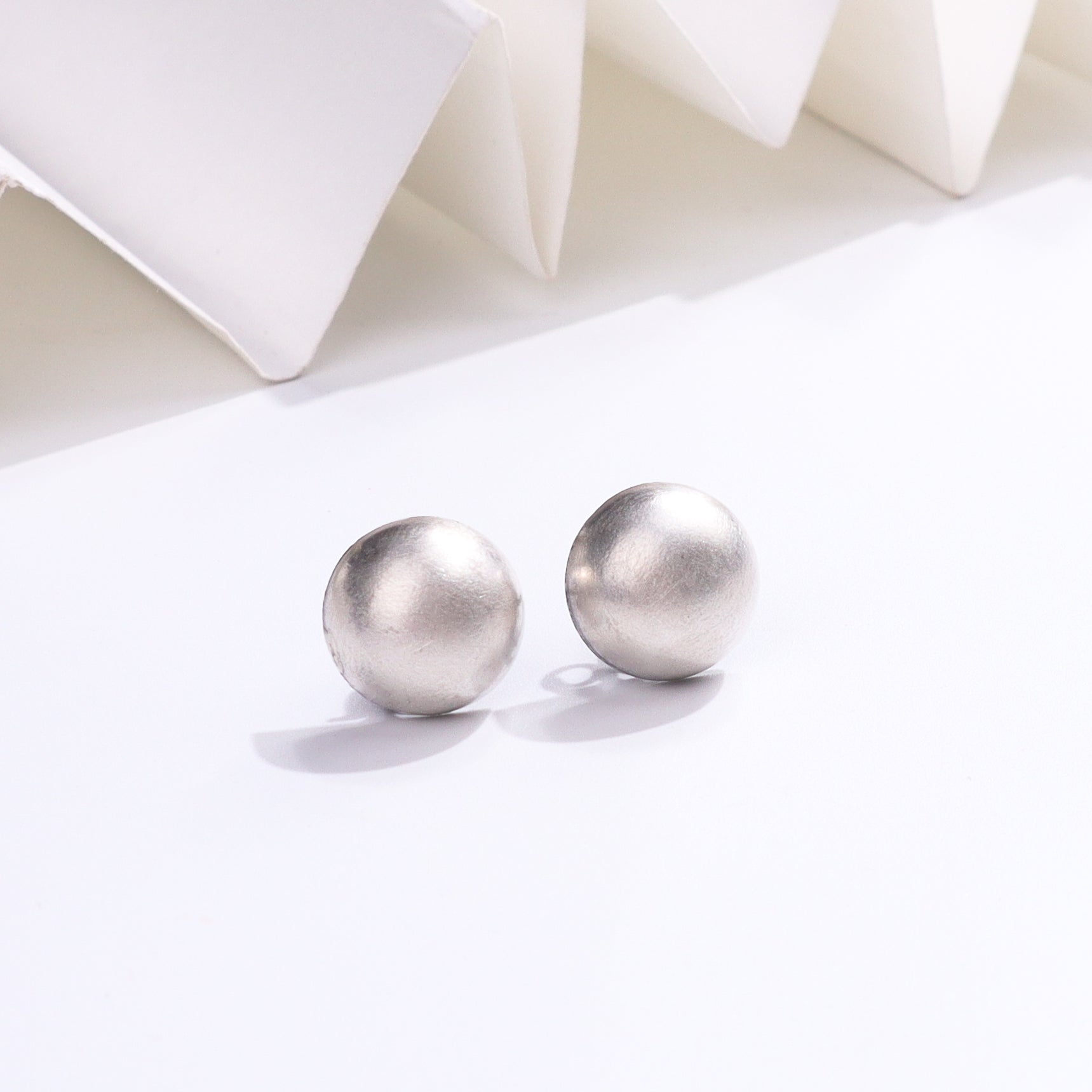 Silver stud earrings with matte finish