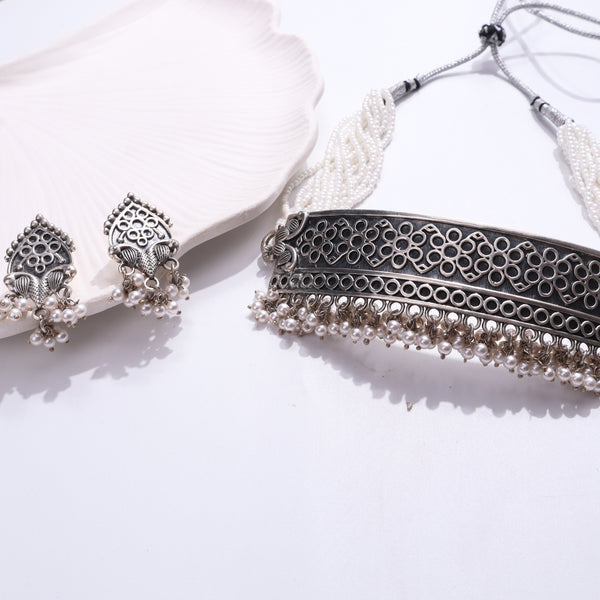 Silver jewelry set with intricate filigree design and pearl accents
