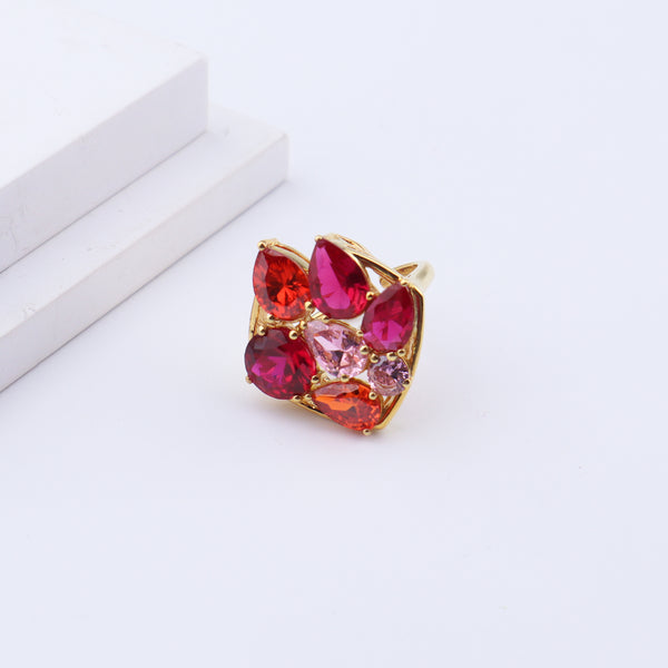 Gold gemstone cluster ring on white background