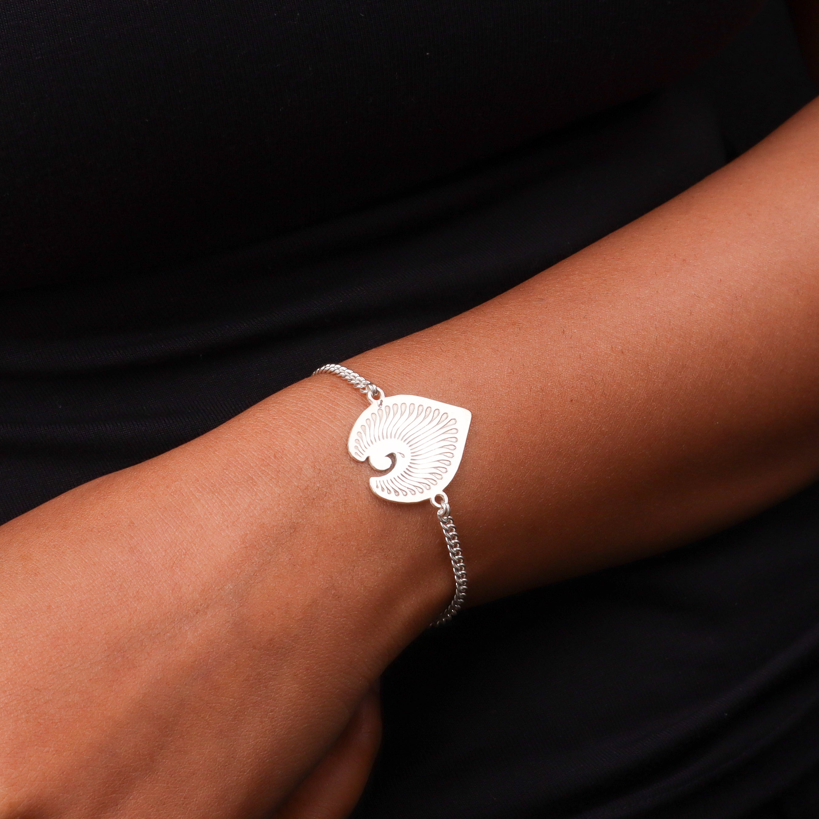 Silver chain bracelet on black fabric