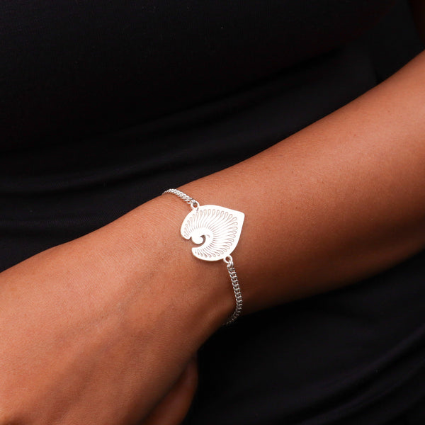 Silver chain bracelet on black fabric