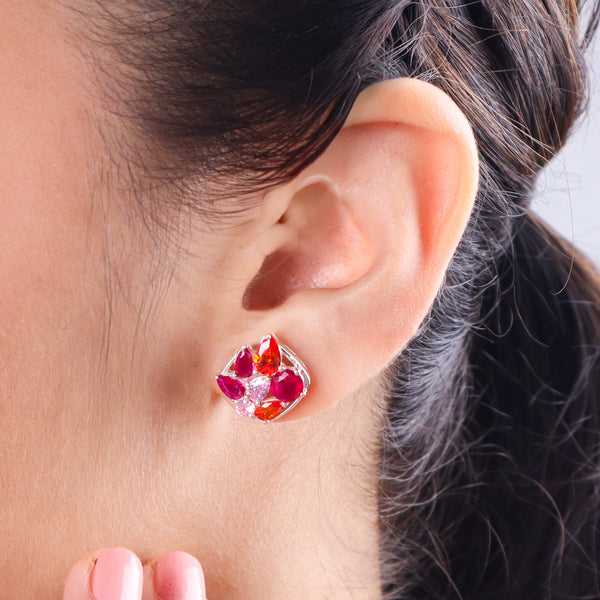 Colorful gemstone earrings worn on ear