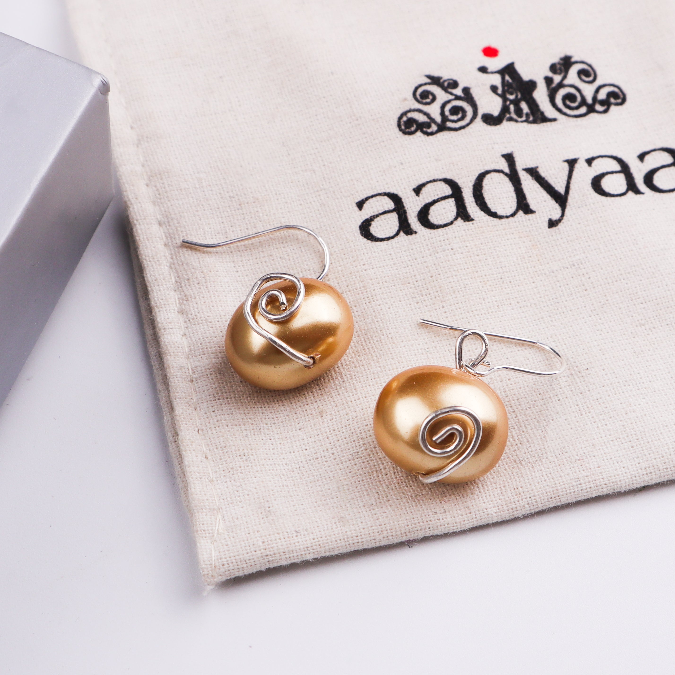 Pearl earrings on white background