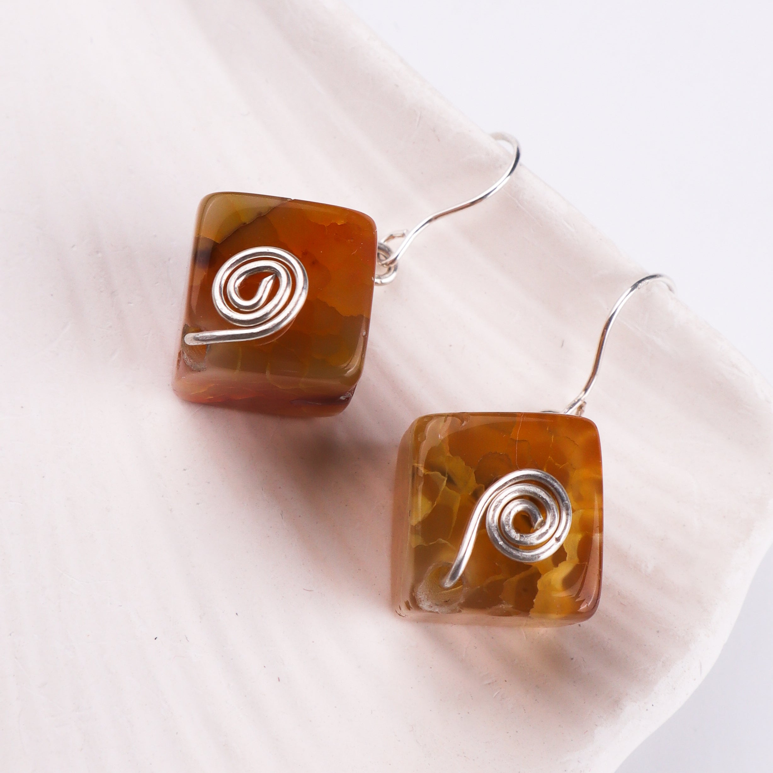 Silver earrings with amber-colored agate