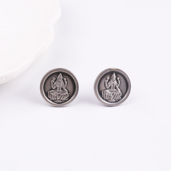 Detailed view of goddess Lakshmi embossed silver earrings