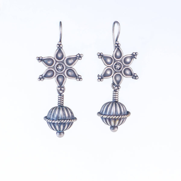 Model wearing Oxidized Flower Spring Dome Earrings