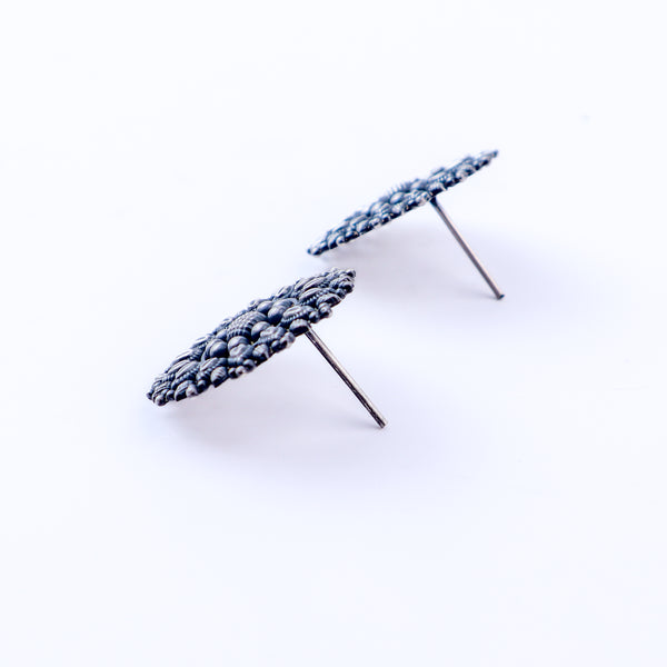 Angled side view of Oxidized Nakshi Earrings in silver