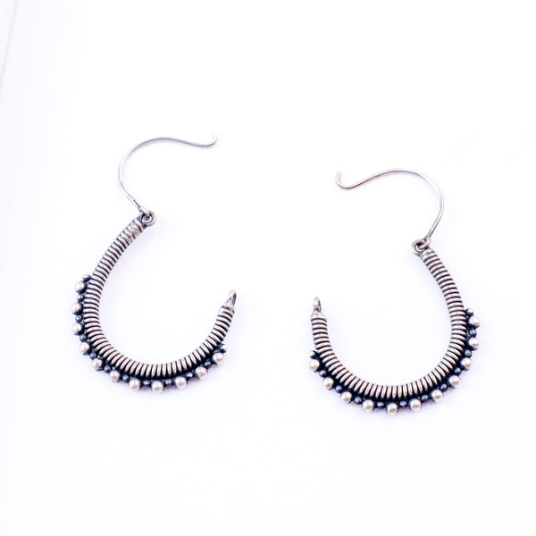 Detail shot highlighting textured oxidized silver coil finish
