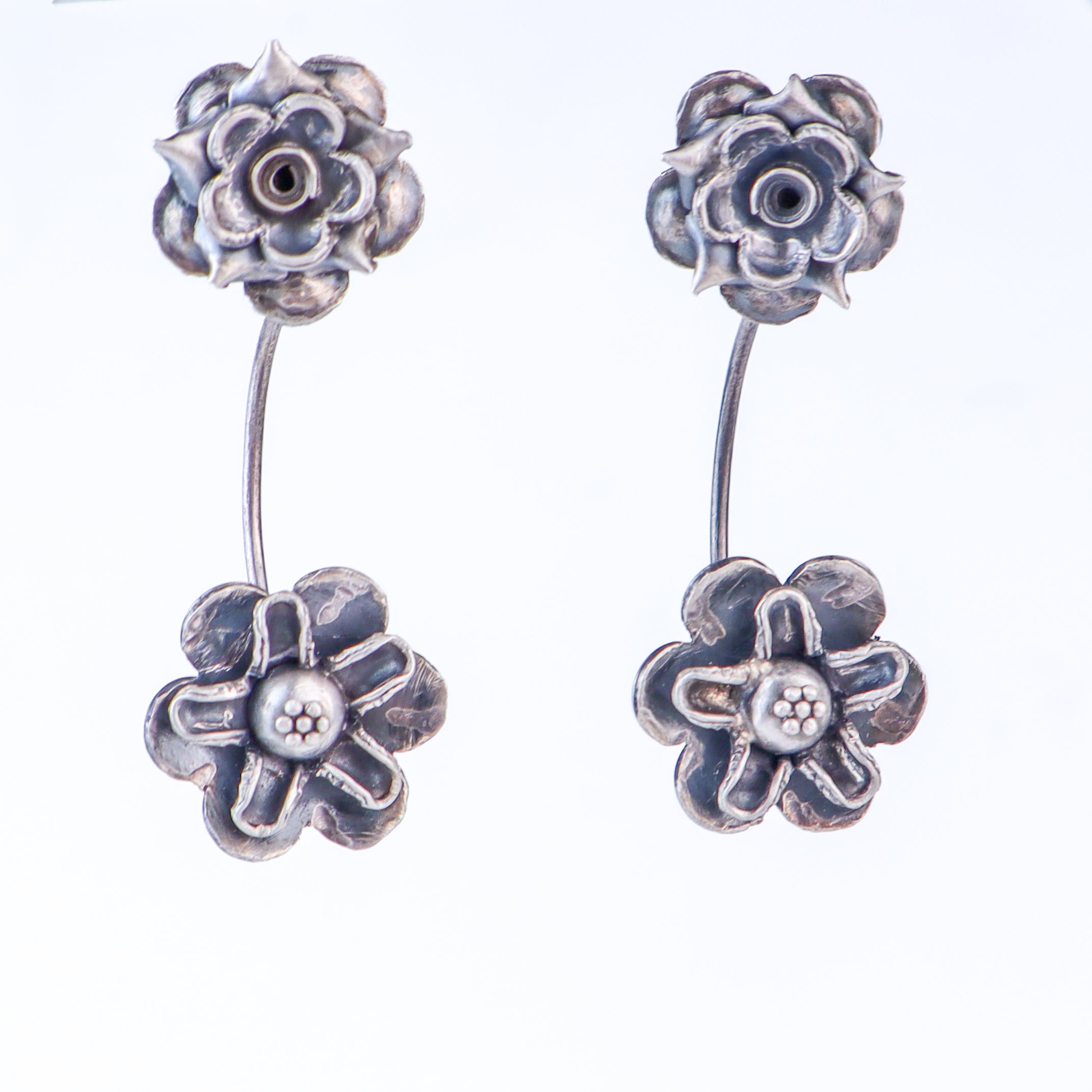 Detail shot highlighting layered floral design and oxidized finish