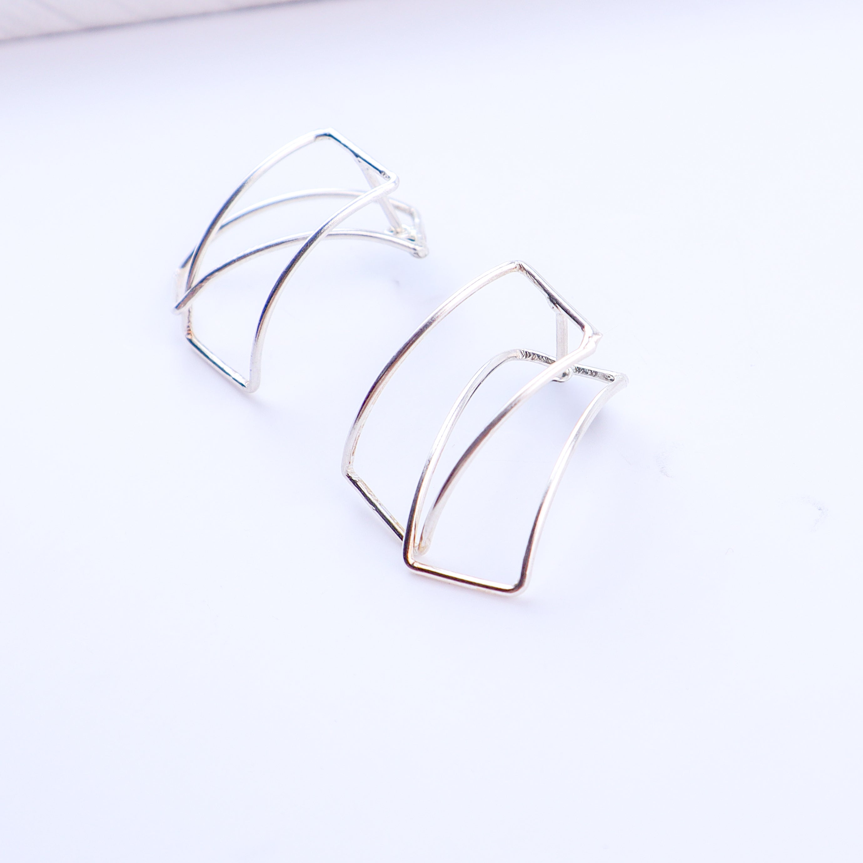 Detail shot highlighting polished silver finish and geometric edges