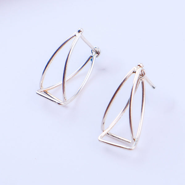 Sterling silver triangle arc earrings on display