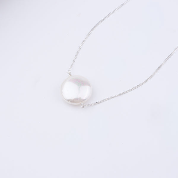 Pearl jewelry set with necklace and earrings on white background