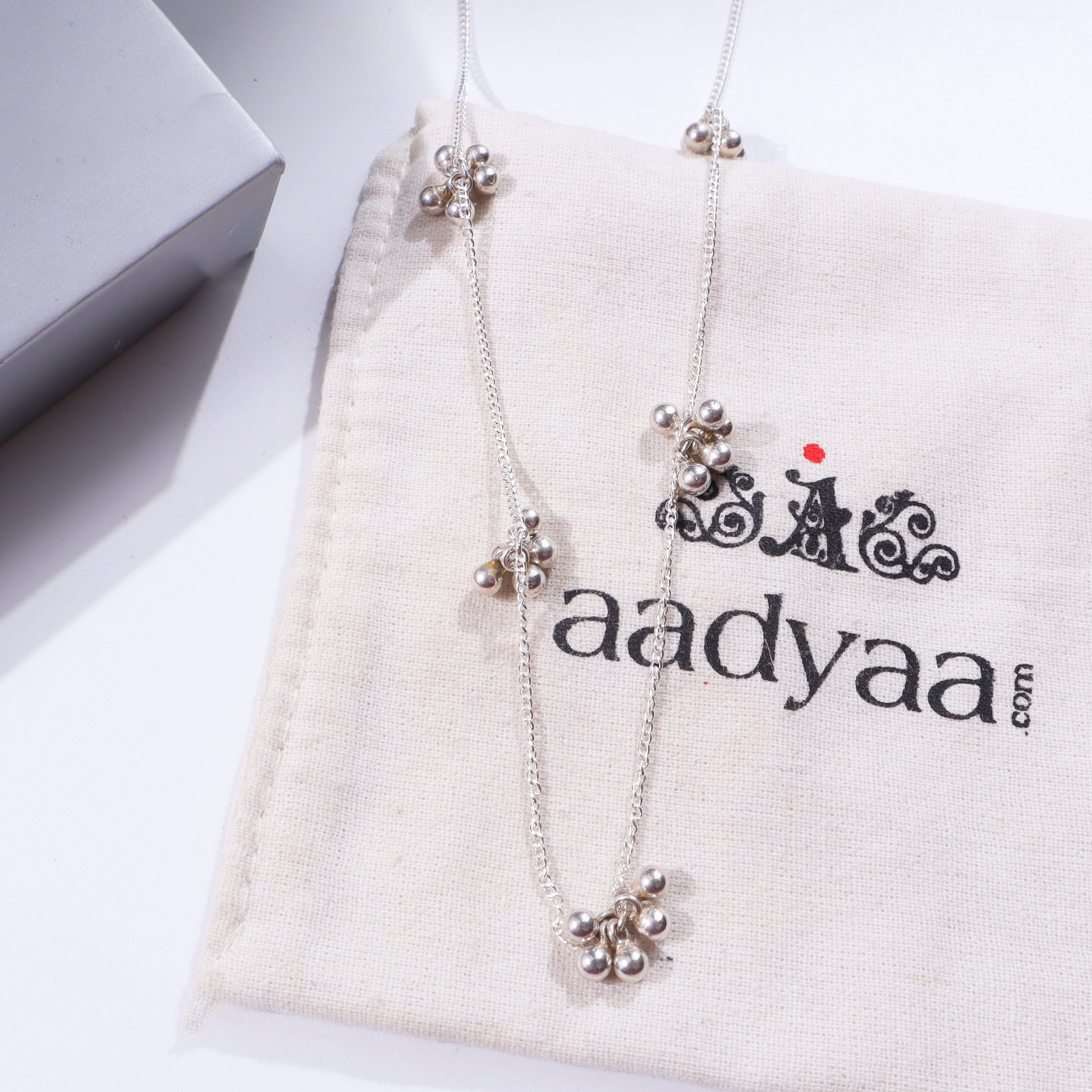 Silver necklace with small ghungroo beads and shiny finish