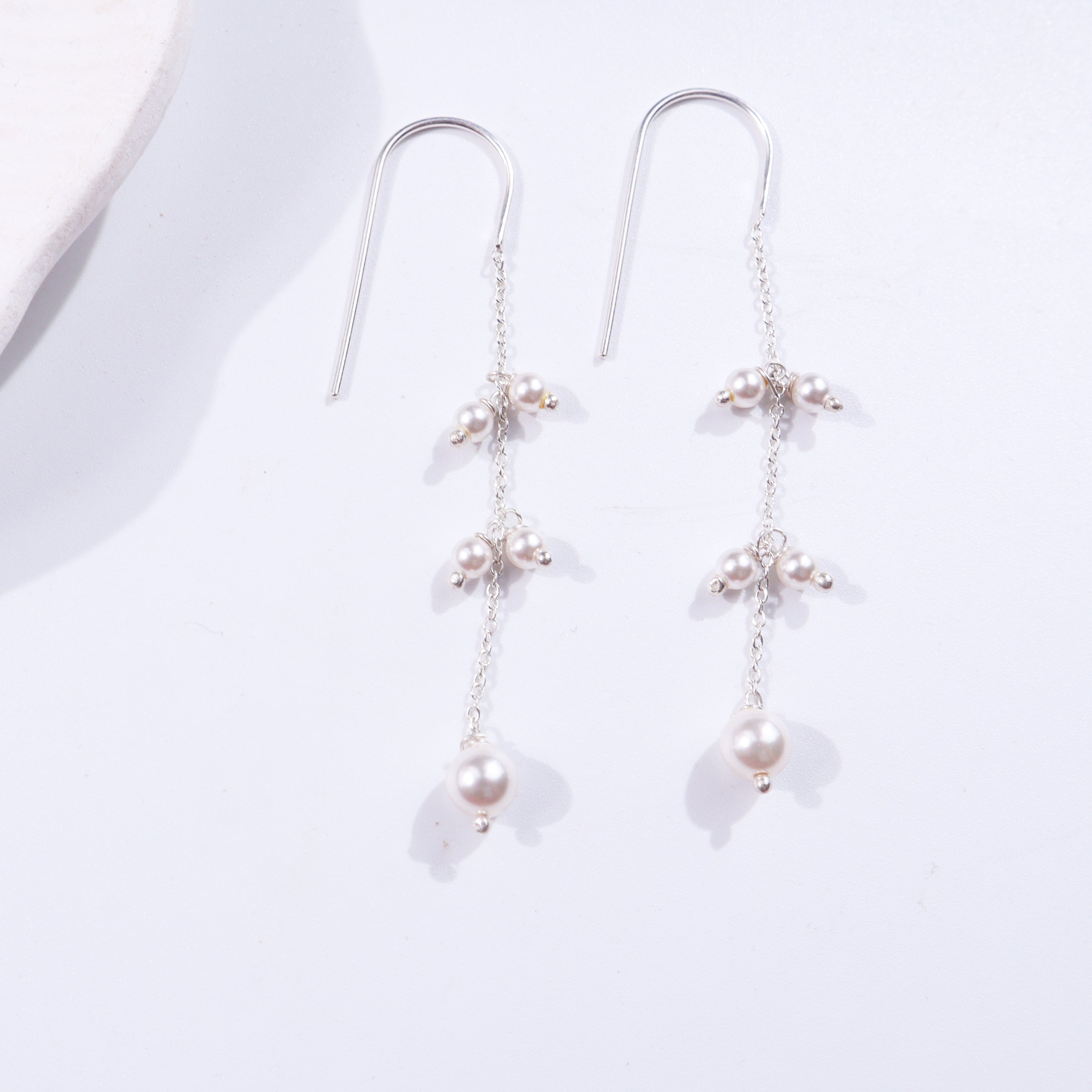 Pearl dangler earrings with silver chain design