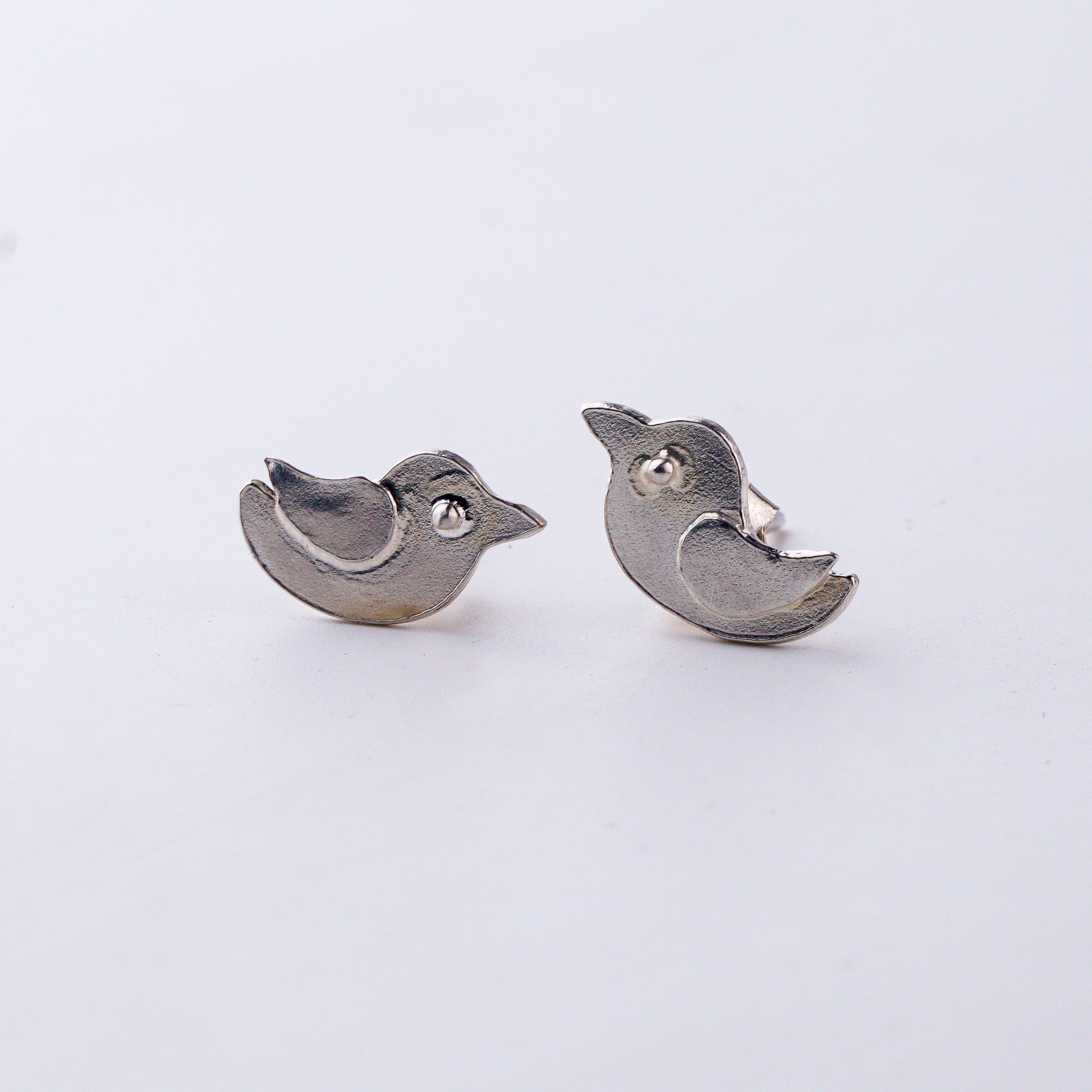 Minimal silver bird motif earrings polished finish