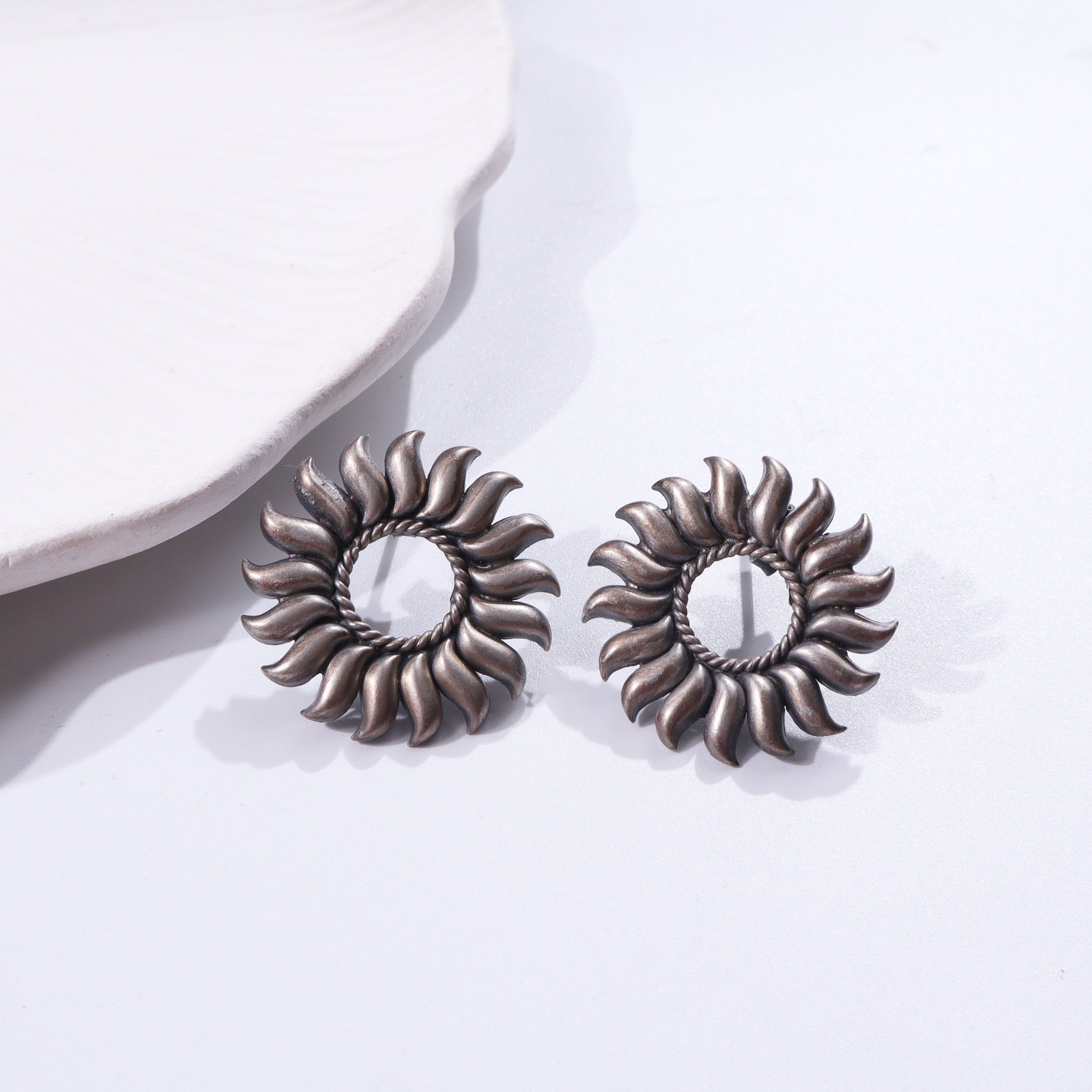 Sterling silver sun-inspired earrings with intricate design