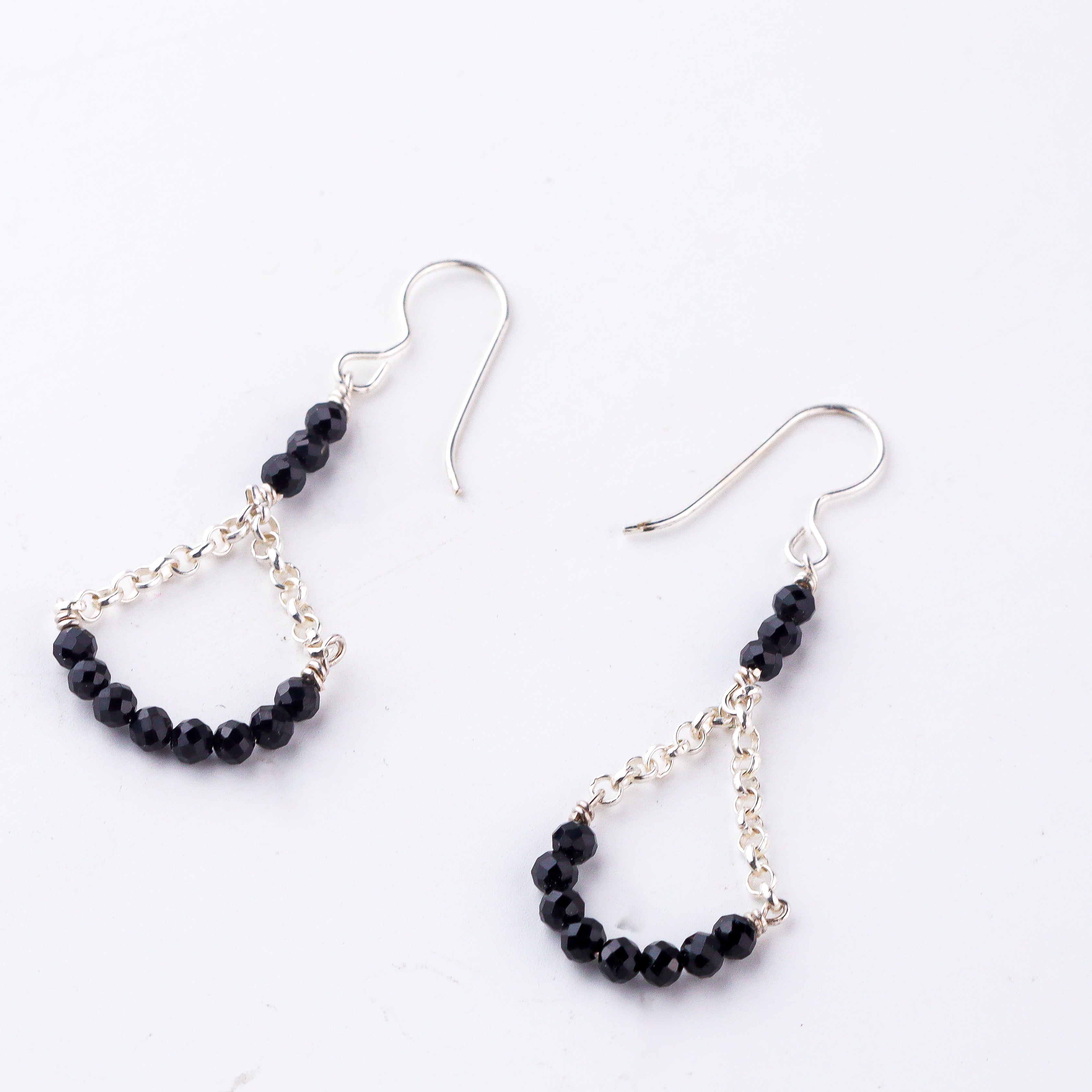 Handcrafted silver earrings with faceted black spinel beads